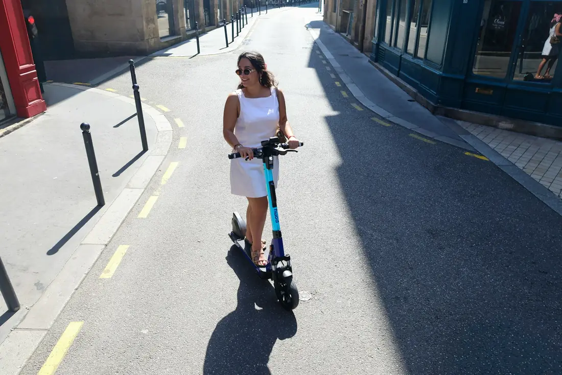 Rider on an electric scooter on a sunny street